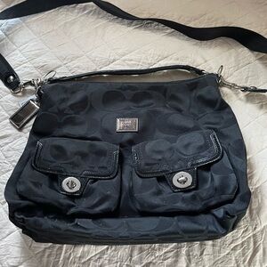 Black with pink interior Coach crossbody or handle purse.